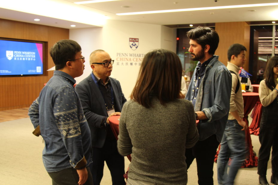 Alumni and students network at the reception.